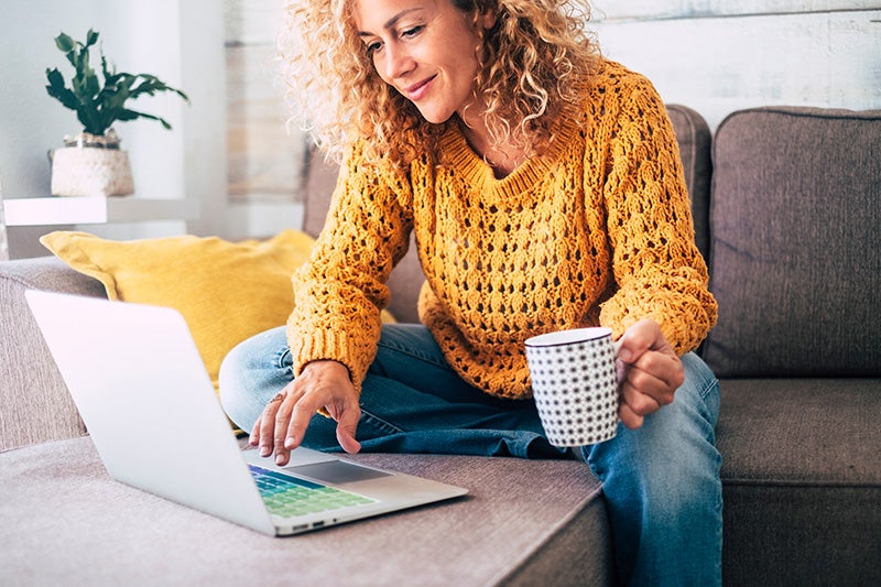 Woman shopping on laptop from home